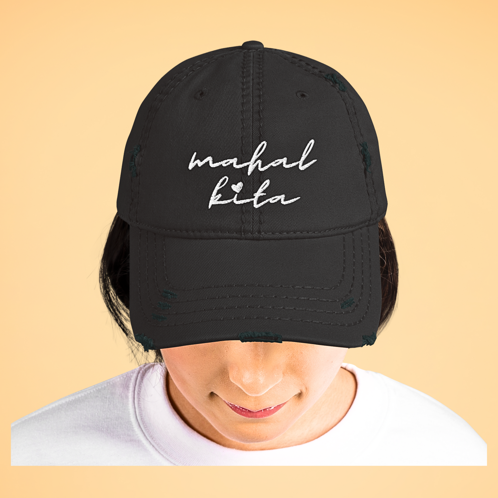 Woman wearing the Mahal Kita Love You Filipino Language Embroidered Distressed Cap