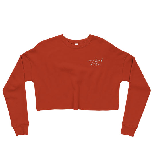 Flat lay view of a crop sweatshirt embroidered with Tagalog phrase, 'mahal kita' in cursive.